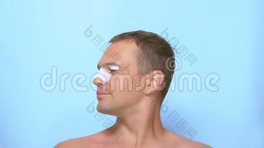 整容的概念，一个男人整容后的脸，隆鼻和睑成形术，与一个